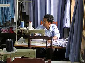 One of two boys in the sewing class