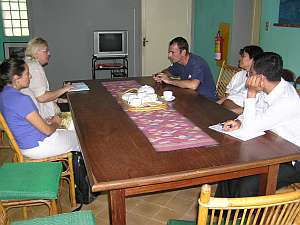 Justin (center) explains the Mith Samlanh program