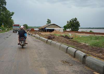 The Mekong River appears next to the road