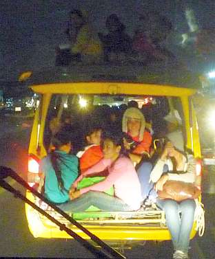 Factory workers crammed into a van